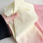A pair of pink-to-yellow gradient compression arm sleeves. Clothifydotpk