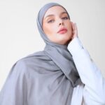 A woman comfortably wearing a modal hijab, highlighting the fabric's fluid drape. Clothifydotpk