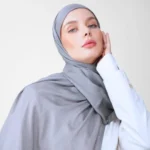 A woman comfortably wearing a modal hijab, highlighting the fabric's fluid drape. Clothifydotpk