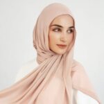 A woman comfortably wearing a modal hijab, highlighting the fabric's fluid drape. Clothifydotpk