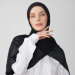 A woman comfortably wearing a modal hijab, highlighting the fabric's fluid drape. Clothifydotpk