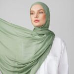 A woman comfortably wearing a modal hijab, highlighting the fabric's fluid drape. Clothifydotpk