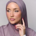 A woman comfortably wearing a modal hijab, highlighting the fabric's fluid drape. Clothifydotpk