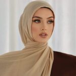A woman comfortably wearing a modal hijab, highlighting the fabric's fluid drape. Clothifydotpk