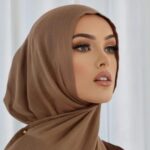A woman comfortably wearing a modal hijab, highlighting the fabric's fluid drape. Clothifydotpk