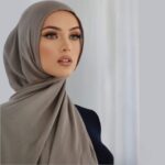 A woman comfortably wearing a modal hijab, highlighting the fabric's fluid drape. Clothifydotpk