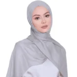 A woman comfortably wearing a modal hijab, highlighting the fabric's fluid drape. Clothifydotpk