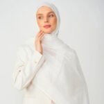 A woman comfortably wearing a modal hijab, highlighting the fabric's fluid drape. Clothifydotpk