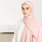 A woman wearing a draped ribbed jersey hijab. Clothifydotpk