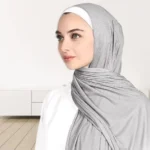 A woman wearing a draped ribbed jersey hijab. Clothifydotpk