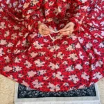 A woman using a Winter Namaz Chadar, performing namaz. Clothifydotpk