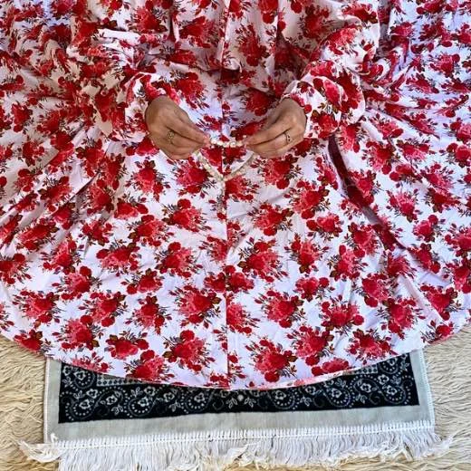 A woman using a Winter Namaz Chadar, performing namaz. Clothifydotpk