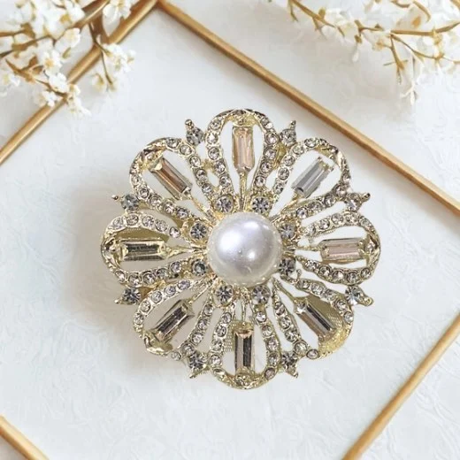 A floral brooch in shades of silver. By Clothifydotpk