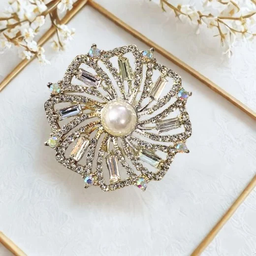 A floral brooch in shades of silver. By Clothifydotpk