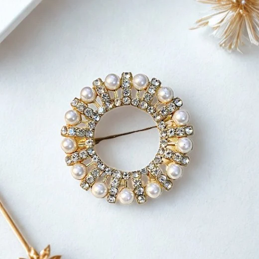 A floral brooch in shades of golden. By Clothifydotpk