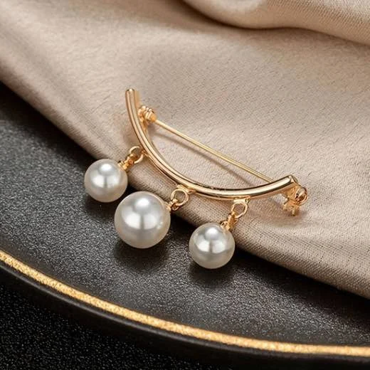 A gold brooch with three white pearl. By Clothifydotpk