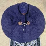 A young kid wearing a Namaz Chadar, made from breathable fabric. By Clothifydotpk