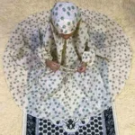 A young kid wearing a Namaz Chadar, made from breathable fabric. By Clothifydotpk