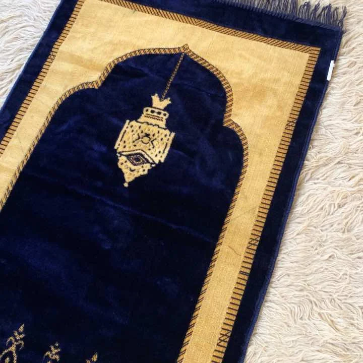 A beautifully patterned premium carpet prayer mat laid out flat. By Clothifydotpk