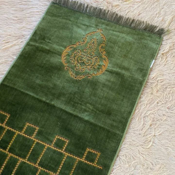 A beautifully patterned premium carpet prayer mat laid out flat. By Clothifydotpk