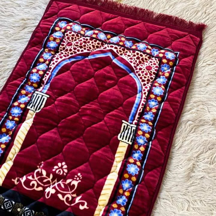 A beautifully patterned quilted prayer mat laid out flat By Clothifydotpk