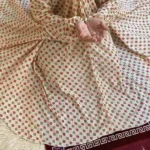 A women peacefully performing salah wearing printed namaz chadar.