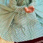 A women peacefully performing salah wearing printed namaz chadar.