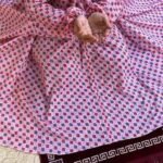 A women peacefully performing salah wearing printed namaz chadar.