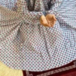 A women peacefully performing salah wearing printed namaz chadar.