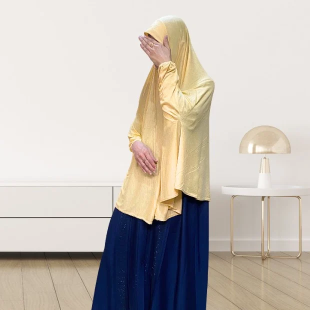 A woman wearing a jersey makhna hijab, providing full coverage for the head, neck, and shoulders without pins. CLOTHIFYDOTPK