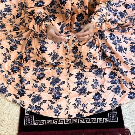 A woman using a Winter Namaz Chadar, performing namaz By Clothifydotpk