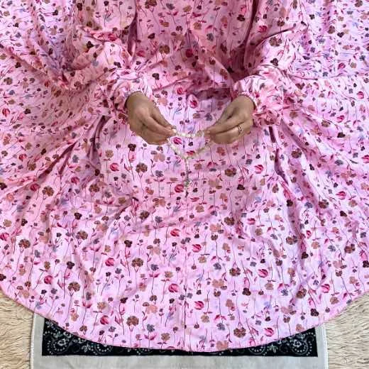 A woman using a Winter Namaz Chadar, performing namaz By Clothifydotpk