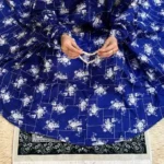 A woman using a Winter Namaz Chadar, performing namaz By Clothifydotpk