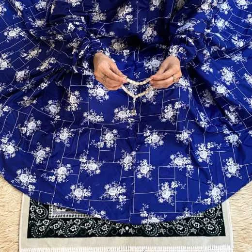 A woman using a Winter Namaz Chadar, performing namaz By Clothifydotpk