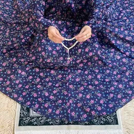 A woman using a breathable soft swiss lawn Namaz Chadar with Sleeves, performing salah By Clothifydotpk