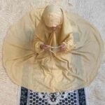 a kid with plain namaz chadar with sleeves offering salah. By Clothifydotpk