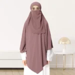 A woman wearing a long, single layer khimar that drapes over the head, and shoulders, falling to about waist length.