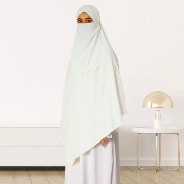 A woman wearing a long, single layer khimar that drapes over the head, and shoulders, falling to about waist length.