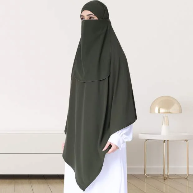 A woman wearing a long, single layer khimar that drapes over the head, and shoulders, falling to about waist length.