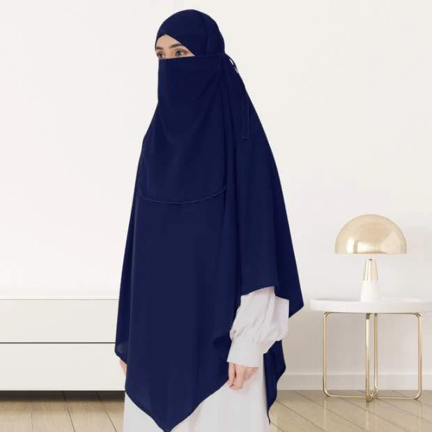 A woman wearing a long, single layer khimar that drapes over the head, and shoulders, falling to about waist length.