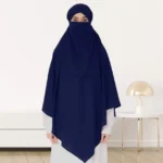 A woman wearing a long, single layer khimar that drapes over the head, and shoulders, falling to about waist length.