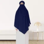 A woman wearing a long, single layer khimar that drapes over the head, and shoulders, falling to about waist length.