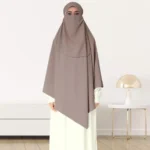 A woman wearing a long, single layer khimar that drapes over the head, and shoulders, falling to about waist length.