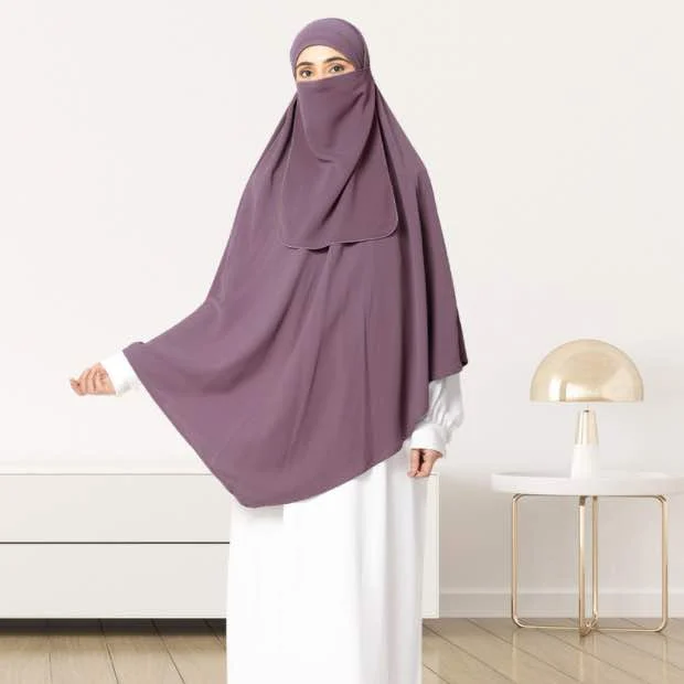 A woman wearing a long, single layer khimar that drapes over the head, and shoulders, falling to about waist length.