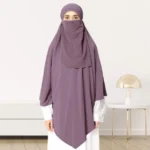 A woman wearing a long, single layer khimar that drapes over the head, and shoulders, falling to about waist length.