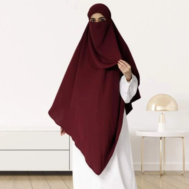 A woman wearing a long, single layer khimar that drapes over the head, and shoulders, falling to about waist length.