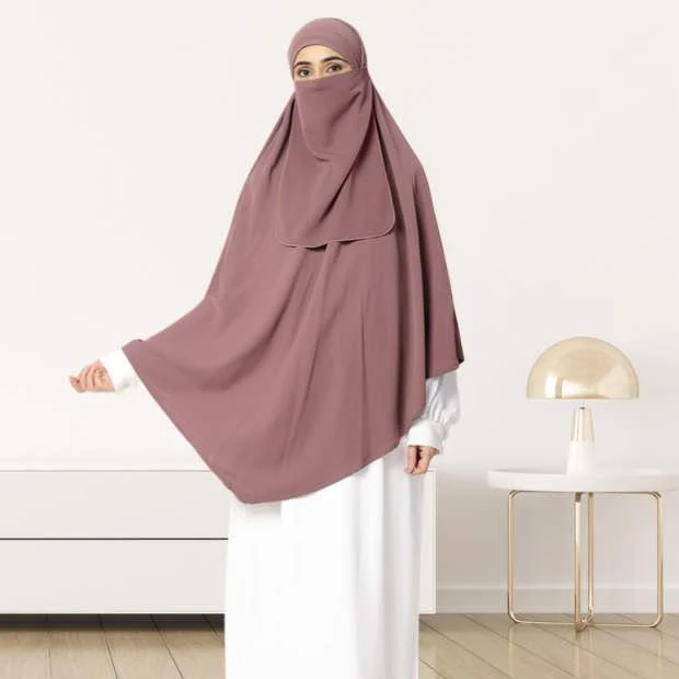 A woman wearing a long, single layer khimar that drapes over the head, and shoulders, falling to about waist length.