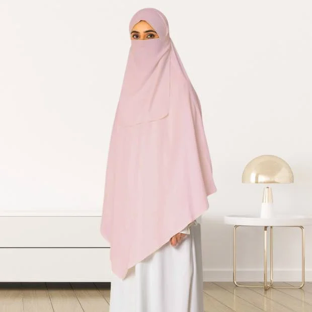 A woman wearing a long, single layer khimar that drapes over the head, and shoulders, falling to about waist length.