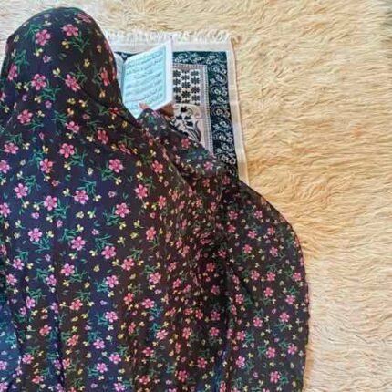 A woman using a lightweight, sleeve-less namaz chadar design during Salah.