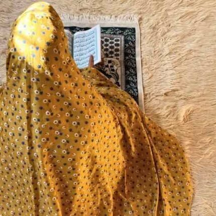 A woman using a lightweight, sleeve-less namaz chadar design during Salah.